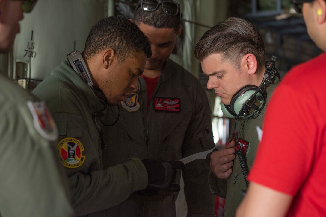 Senior Airman Warren Kadeem, 36th Airlift Squadron loadmaster, left, and Master Sgt. Timothy J. Johnson, 374th Operations Support Squadron Wing weapons and tactics flight chief, right, prepare to respond to an aeromedical evacuation scenario during the Yokota C‐130J Tactics Rodeo April 3, 2020, at Yokota Air Base, Japan.