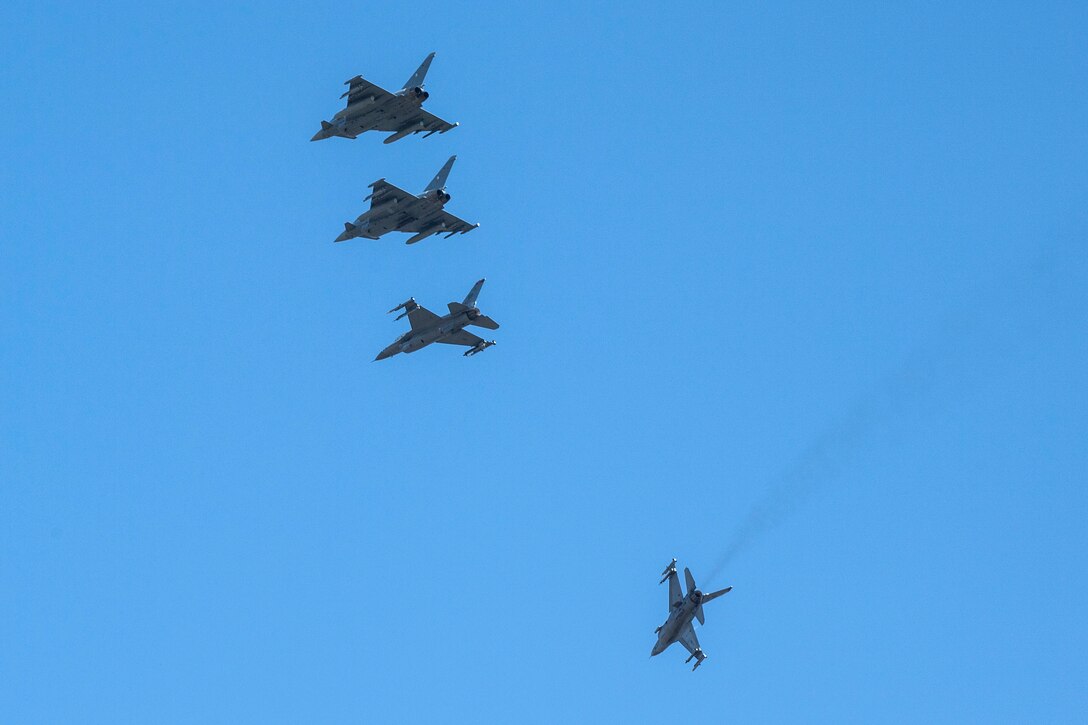 U.S. Fighting Falcons and German Eurofighter Typhoons fly in formation.
