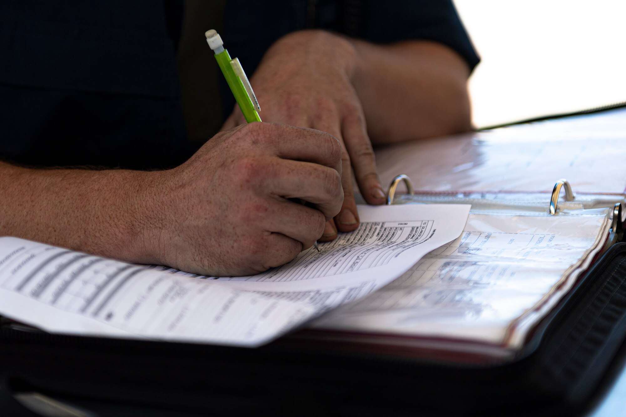 A photo of an Airman filling out paperwork