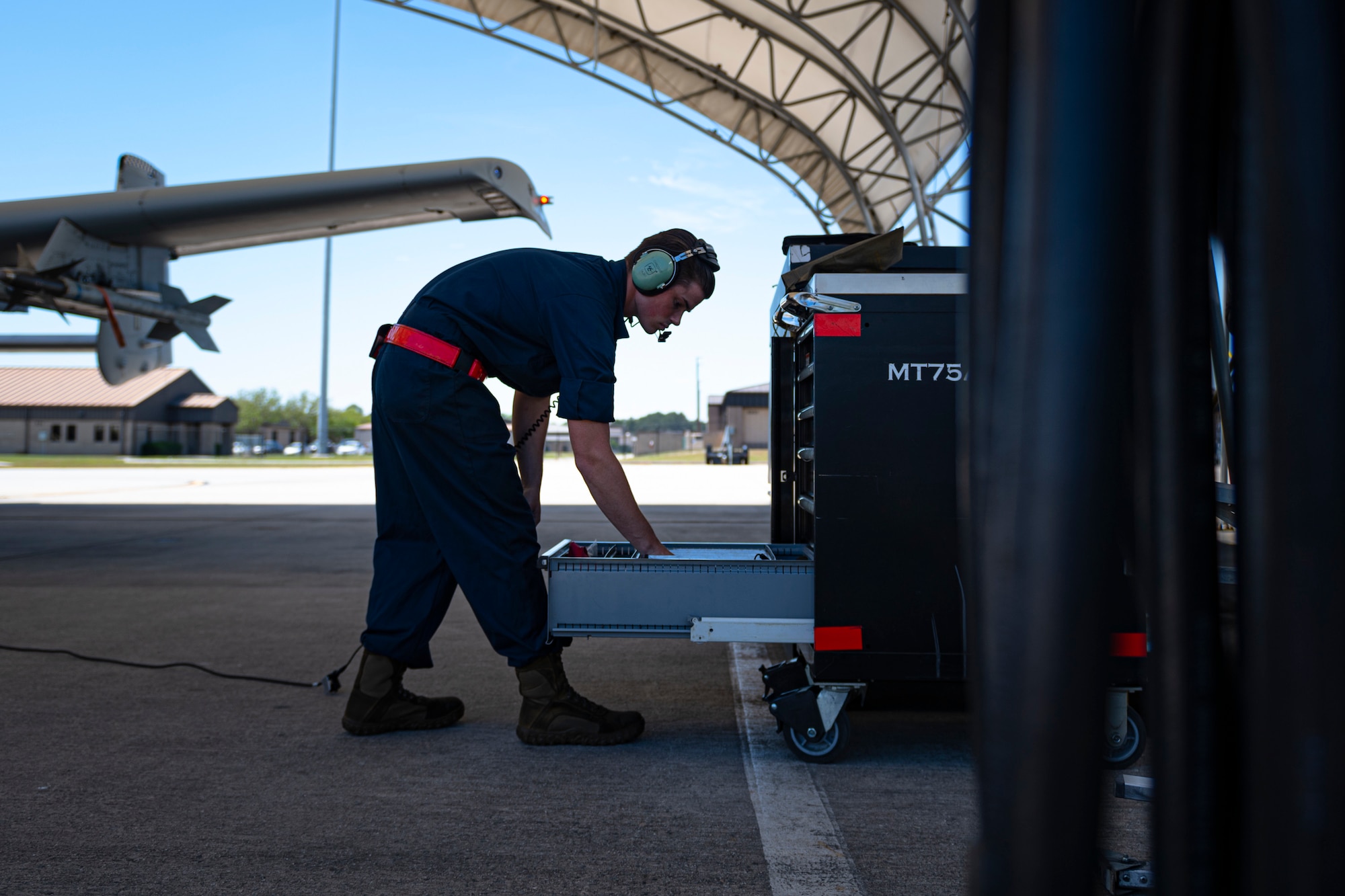 A photo of an Airman gathering tools from a toolbox