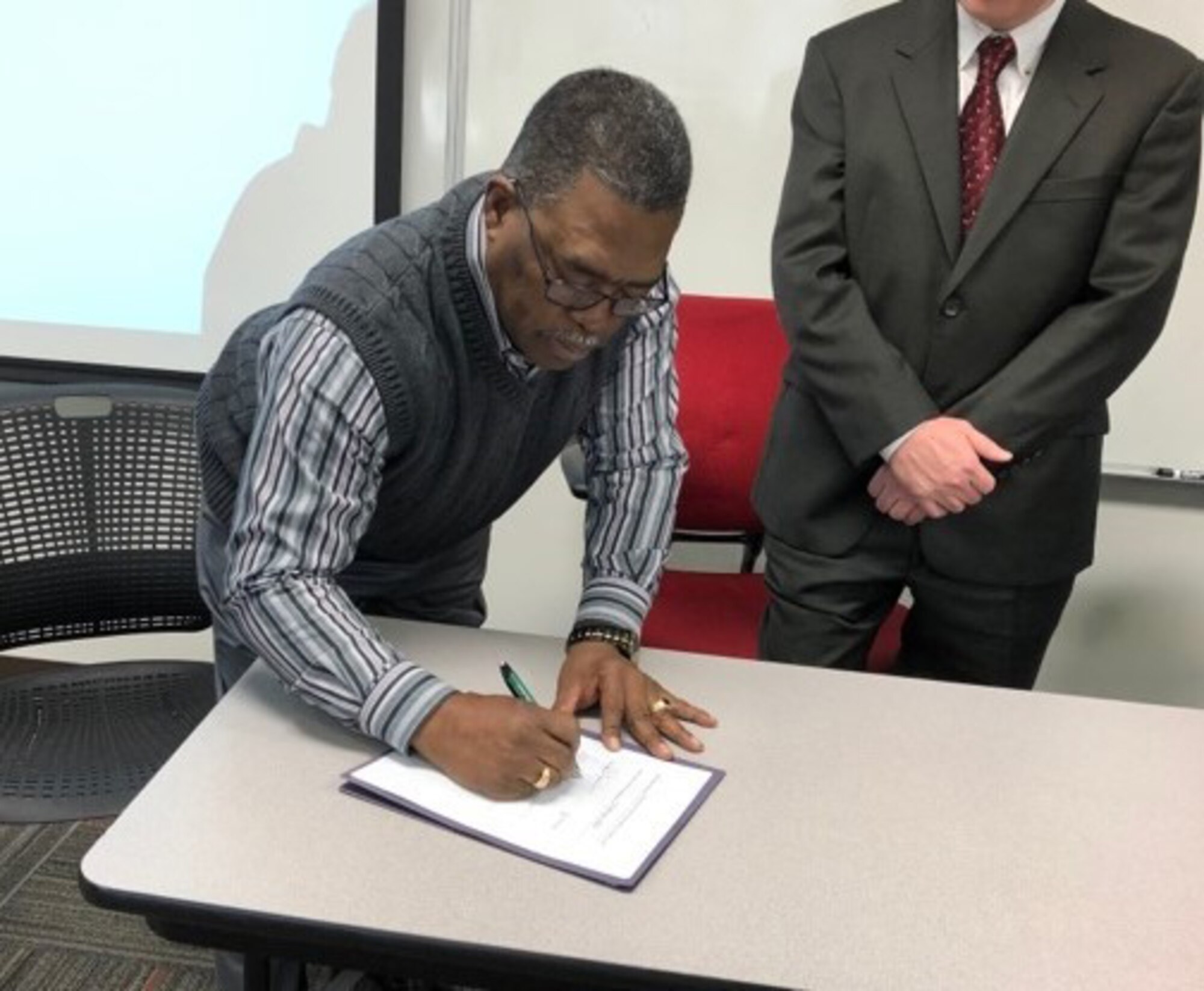 Galen Williams, director of Safety for Hanscom Air Force Base and vice president of the Greater Boston Field Federal Safety and Health Council, signs the council’s charter at the Occupational Safety and Health Administration’s Training Institute in Manchester, N.H., Jan. 30. The council will be fully operational, once the charter is signed by the Secretary of Labor. (Courtesy photo)