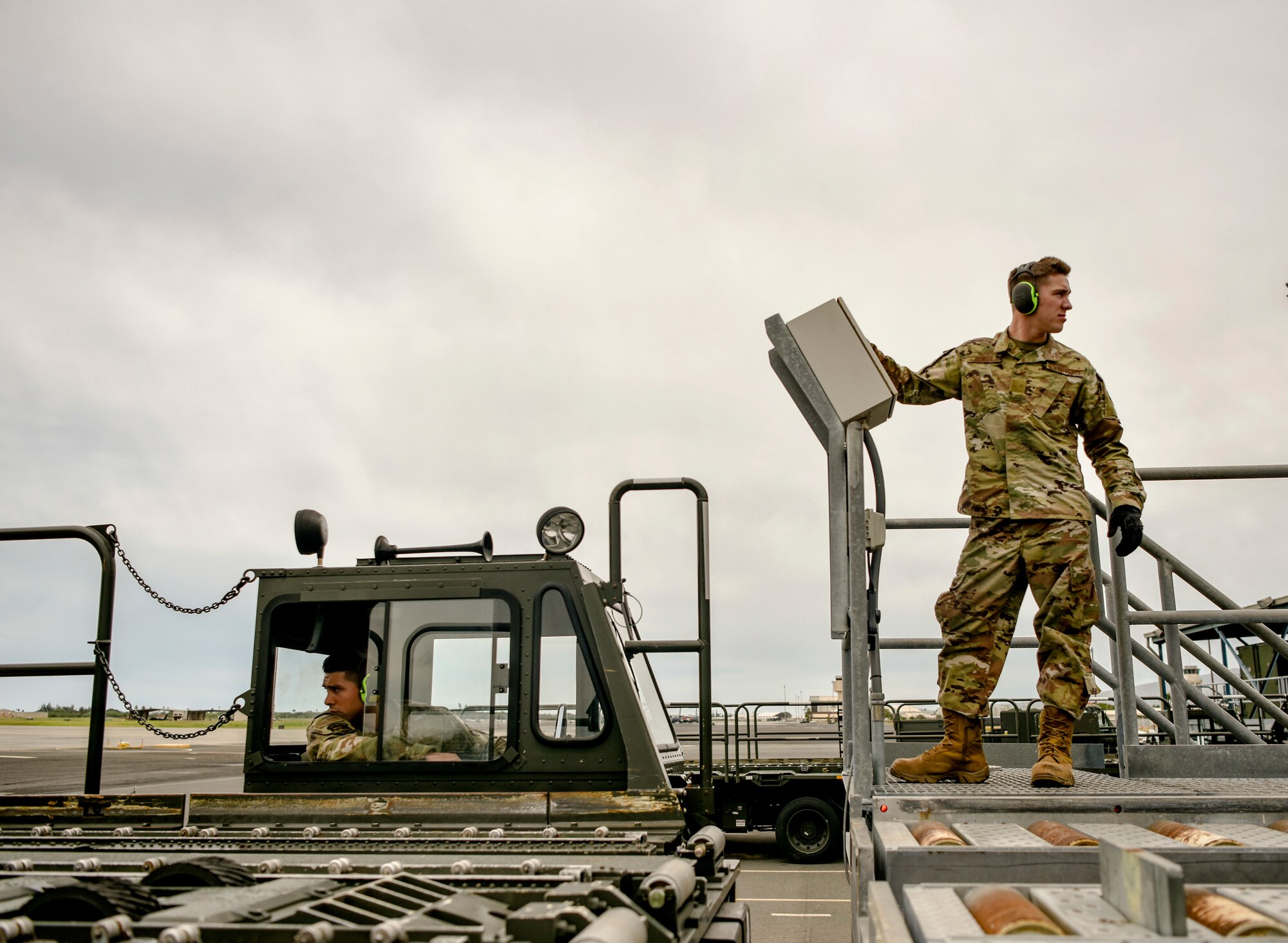 U.S. Air Force Senior Airman Mario Garcia and Airman Basic Brock Dowell, 735th Air Mobility Squadron air freight personnel,  load cargo on and off of a Tunner 60K loader into a dock at Joint Base Pearl Harbor-Hickam, Hawaii, March 31, 2020. The 735th AMS supports global airlift in the Indo-Pacific area. (U.S. Air Force photo by Tech. Sgt. Anthony Nelson Jr.)