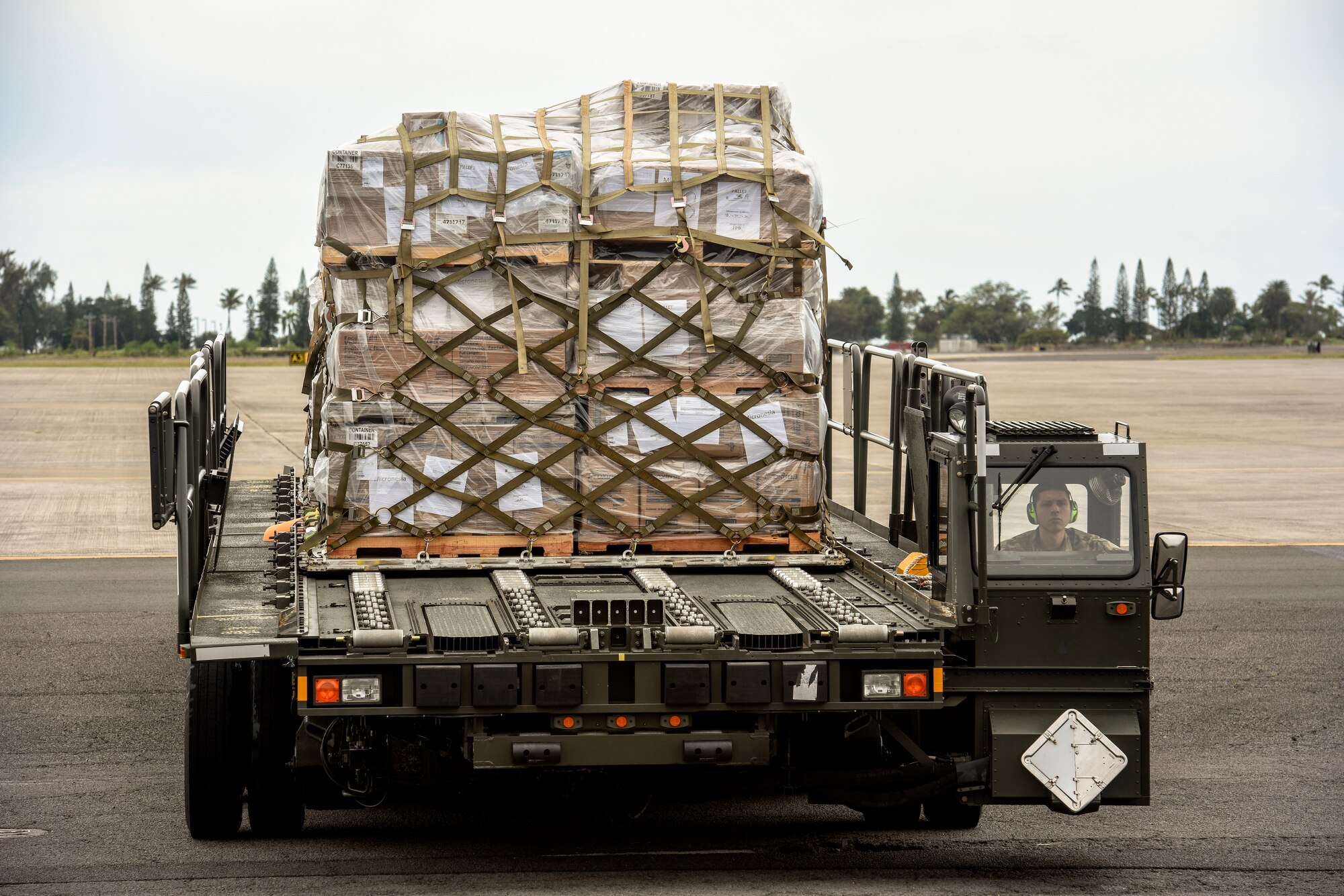 U.S. Air Force Senior Airman Mario Garcia, 735th Air Mobility Squadron air freight journeyman, drives a Tunner 60K loader with cargo to the 735th AMS dock at Joint Base Pearl Harbor-Hickam, Hawaii, March 31, 2020. The 735th AMS supports global airlift in the Indo-Pacific region. (U.S. Air Force photo by Tech. Sgt. Anthony Nelson Jr.)