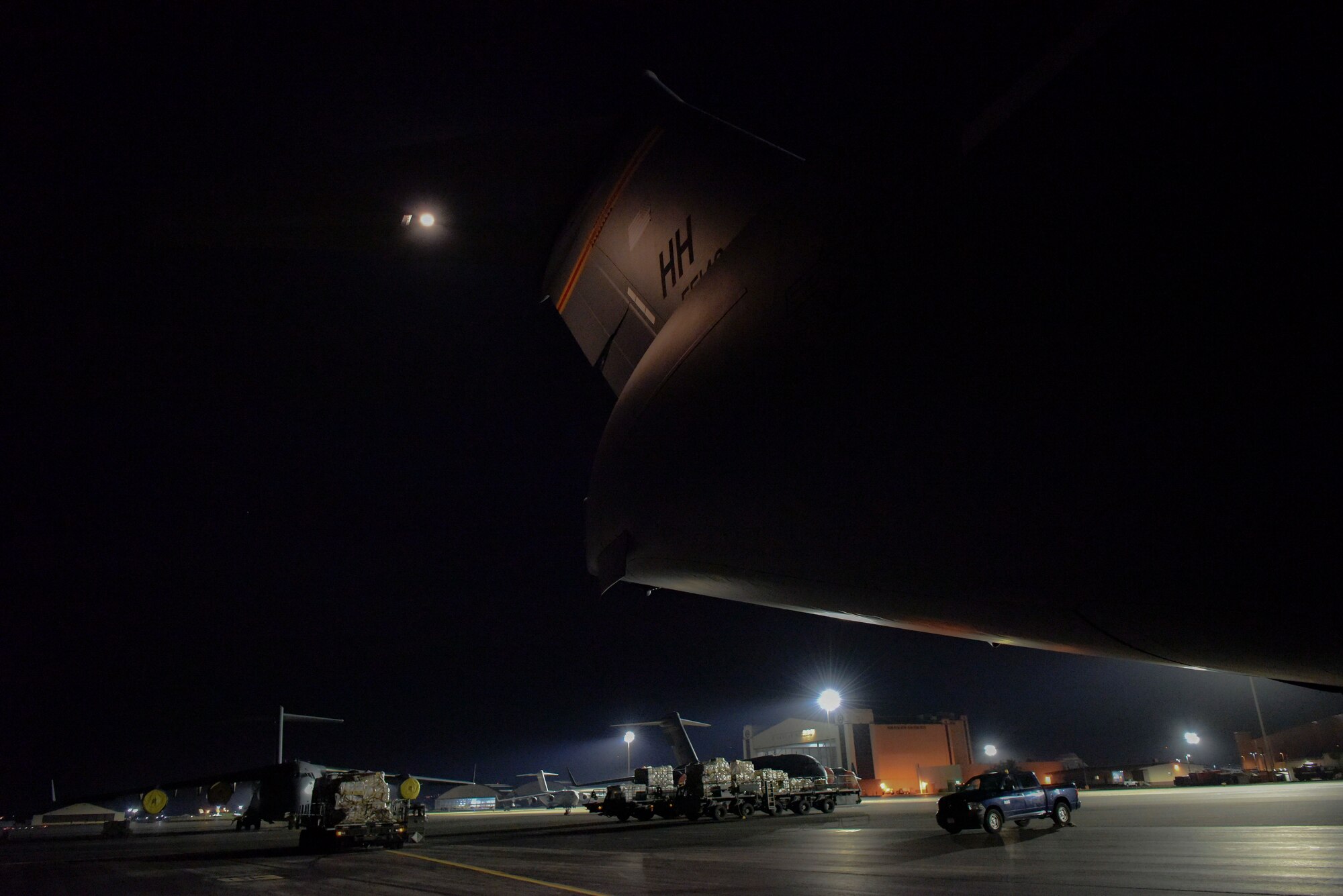 A 535th Airlift Squadron A C-17 Globemaster III  sits on the flightline at Joint Base Pearl Harbor-Hickam, Hawaii, April  3, 2020.  The 735th Air Mobility Squadron loaded 31,063 pounds of cargo containing COVID-19 personal protective equipment and medical supplies from the CDC and FEMA that were delivered to the Mariana Islands.  (U.S. Air Force photo by Tech. Sgt. Anthony Nelson Jr.)
