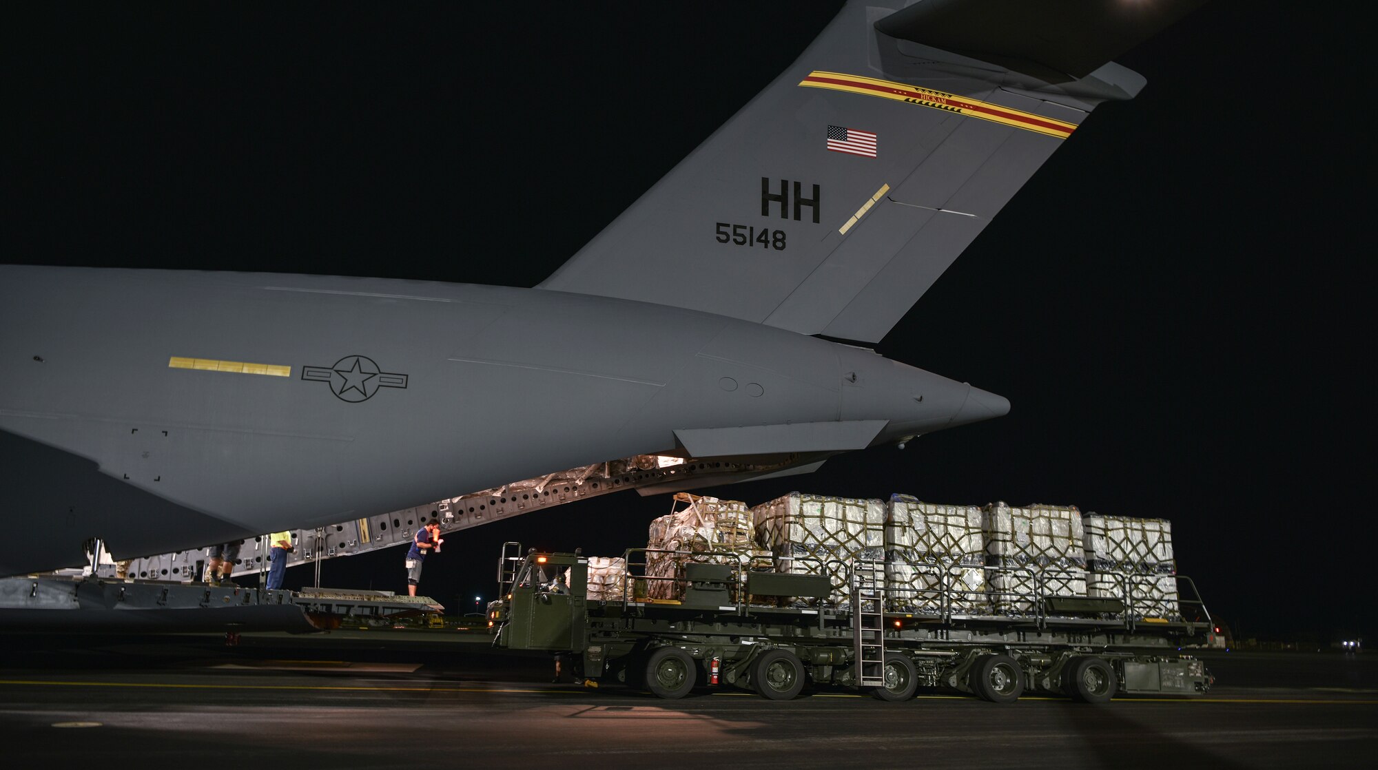 U.S. Air Force Airmen and civilians from the 735th Air Mobility Squadron load COVID-19 personal protective equipment and medical supplies onto a C-17 Globemaster III from the 535th Airlift Squadron at Joint Base Pearl Harbor-Hickam, Hawaii, April  3, 2020. The 735th Air Mobility Squadron loaded 31,063 pounds of cargo containing COVID-19 personal protective equipment and medical supplies from the CDC and FEMA that were delivered to the Mariana Islands.   (U.S. Air Force photo by Tech. Sgt. Anthony Nelson Jr.)