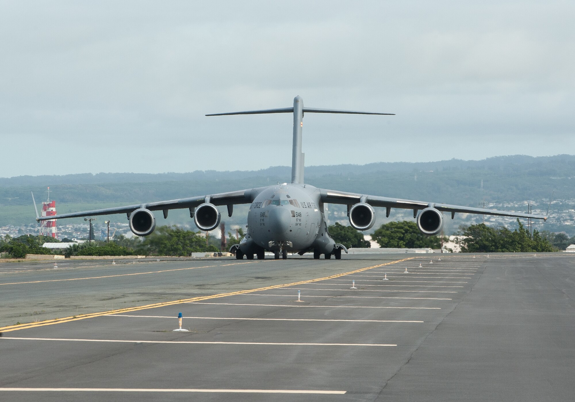 A 535th Airlift Squadron A C-17 Globemaster III  taxis on the flightline at Joint Base Pearl Harbor-Hickam, Hawaii, April  3, 2020.  The 735th Air Mobility Squadron loaded 31,063 pounds of cargo containing COVID-19 personal protective equipment and medical supplies from the CDC and FEMA that were delivered to the Mariana Islands.  (U.S. Air National Guard photo by Senior Airman John Linzmeier)