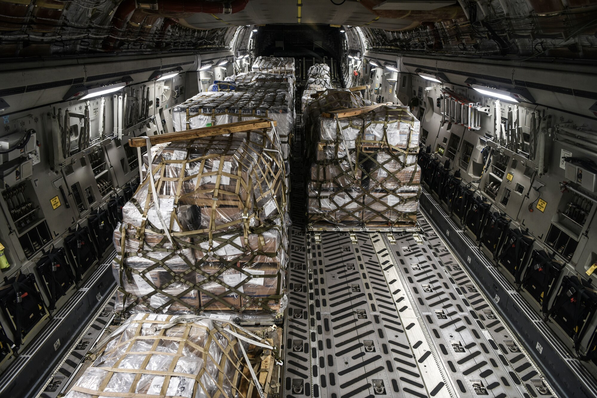 U.S. Air Force Airmen and civilians assigned to the 735th Air Mobility Squadron, load 31,063 pounds of cargo containing COVID-19 personal protective equipment and medical supplies at Joint Base Pearl Harbor-Hickam, Hawaii, April  3, 2020. The 735th AMS provided support to the Mariana Islands in response to the COVID-19 pandemic.  (U.S. Air Force photo by Tech. Sgt. Anthony Nelson Jr.)