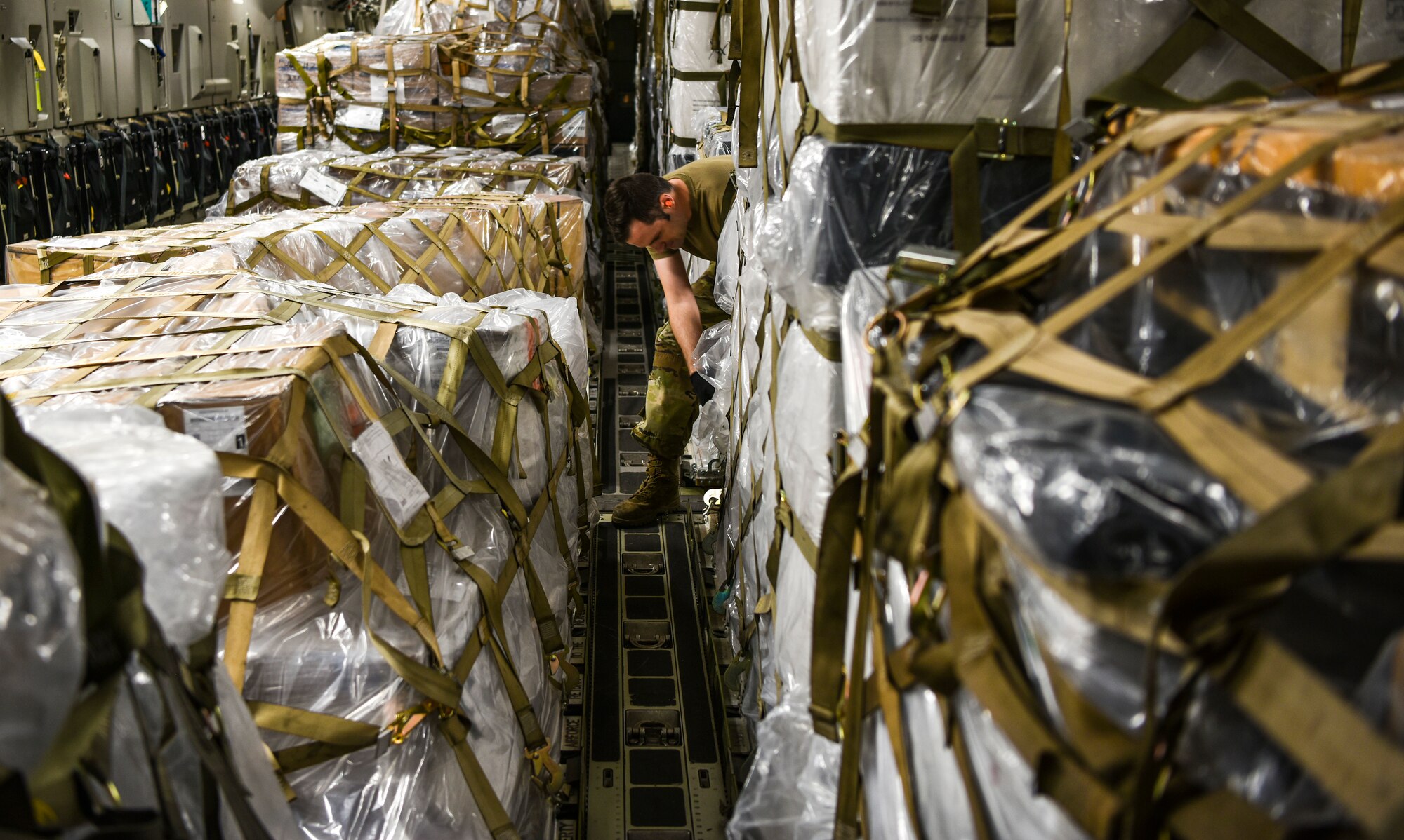 U.S. Air Force Staff Sgt. Charles Brown, 735th Air Mobility Squadron Aircraft services supervisor, inspects pallet placement on a C-17 Globemaster III from the 535th Airlift Squadron at Joint Base Pearl Harbor-Hickam, Hawaii, April  3, 2020.  With a 72-hour notification, the 735th AMS loaded 31,063 pounds of cargo in support of the COVID-19 response. (U.S. Air Force photo by Tech. Sgt. Anthony Nelson Jr.)