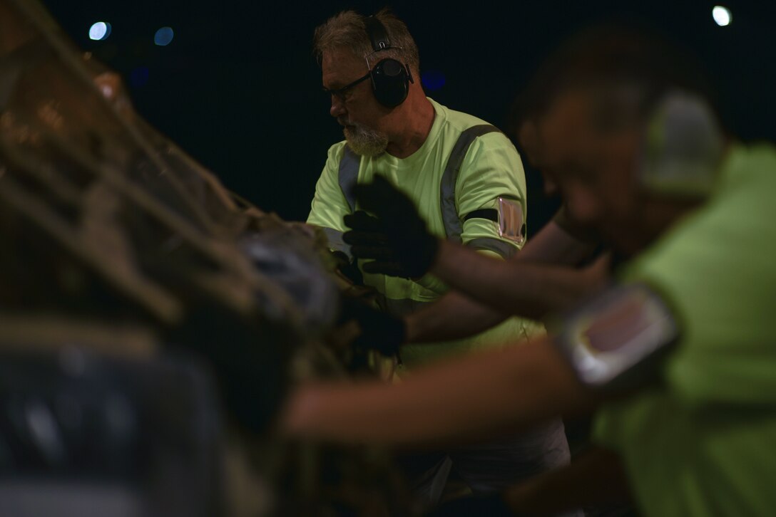 Bruce Miller, 735th Air Mobility Squadron Aircraft loader, moves COVID-19 personal protective equipment and medical supplies onto a  C-17 Globemaster III from the 535th Airlift Squadron at Joint Base Pearl Harbor-Hickam, Hawaii, April  3, 2020. The 735th AMS provided support to the Mariana Islands in response to the COVID-19 pandemic.  

 (U.S. Air Force photo by Tech. Sgt. Anthony Nelson Jr.)