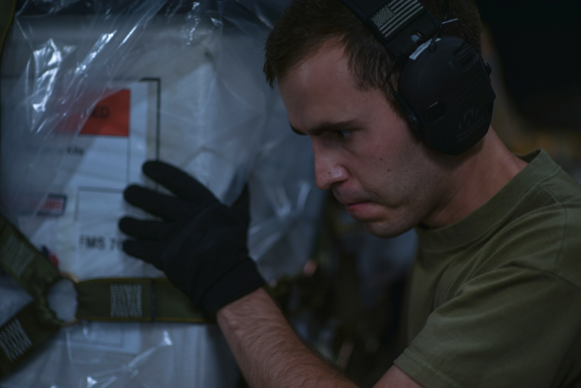 U.S. Air Force Senior Airman Daniel Hofensperger, 735th Air Mobility Squadron air freight journeyman, inspects cargo to ensure pallets are ready for flight at Joint Base Pearl Harbor-Hickam, Hawaii, April  3, 2020. The 735th AMS provided personal protective equipment and medical supplies to the Mariana Islands in response to the COVID-19 pandemic.   (U.S. Air Force photo by Tech. Sgt. Anthony Nelson Jr.)