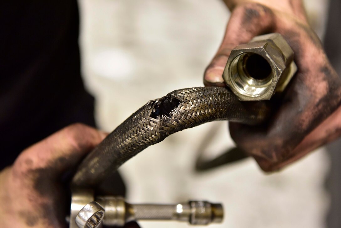 Senior Airman Mathew Bowen, a 354th Logistics Readiness Squadron vehicle maintenance journeyman, inspects a busted air hose on Eielson Air Force Base, Alaska, April 8, 2020. Vehicle mechanics must document and maintain accountability of parts and tools to ensure Air Force assets and funds are used properly and efficiently. (U.S. Air Force photo by Senior Airman Beaux Hebert)