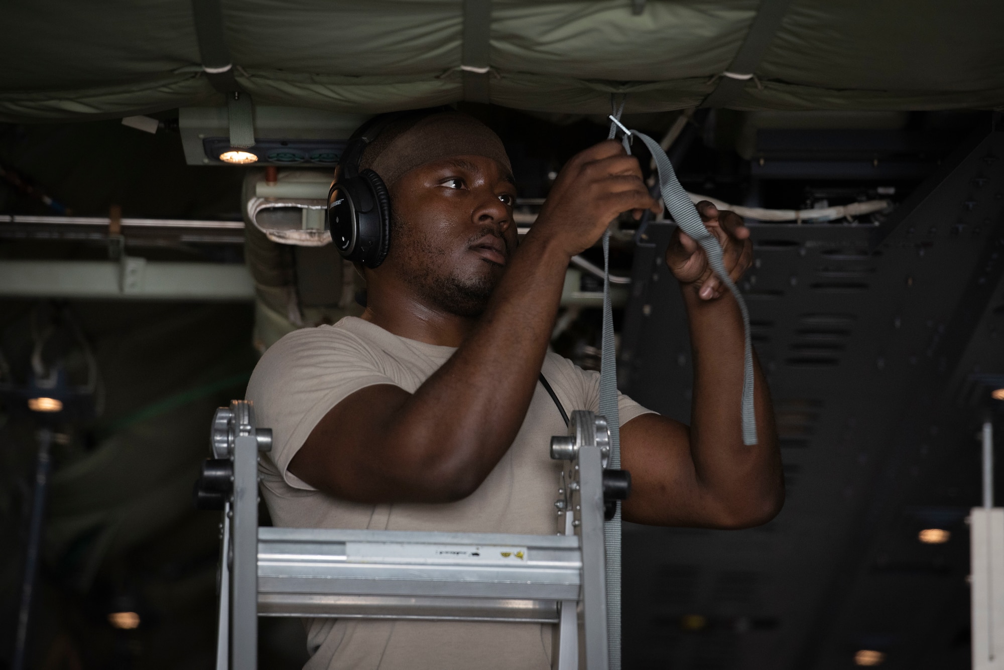 Staff Sgt. Marcus Wright, 36th Airlift Squadron C‐130J Super Hercules loadmaster, hangs a litter strap prior to executing an aeromedical evacuation scenario during the Yokota C‐130J Tactics Rodeo April 3, 2020, at Yokota Air Base, Japan.