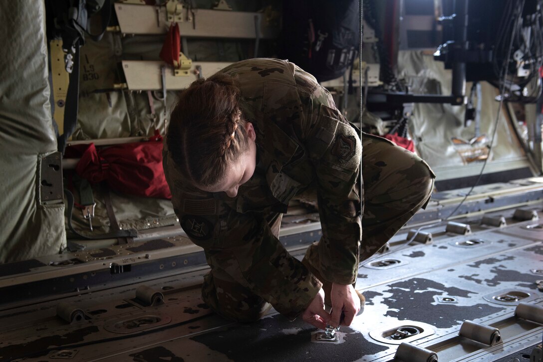 Staff Sgt. Teara Sapp Becker, 36th Airlift Squadron resource advisor, secures a litter strap to execute an aeromedical evacuation scenario during the Yokota C‐130J Tactics Rodeo April 3, 2020, at Yokota Air Base, Japan.