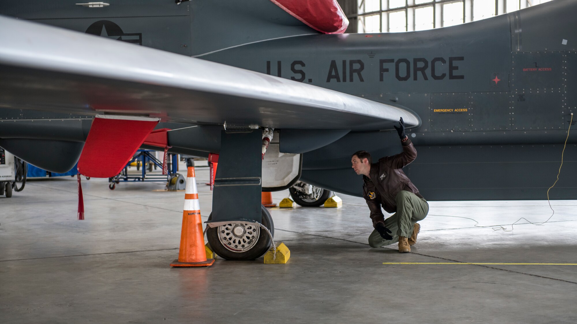 Maj. Marc Nichols, 452nd Flight Test Squadron Assistant Director of Operations, conducts a walk-through inspection of an RQ-4 Global Hawk remotely-piloted aircraft at Edwards Air Force Base, California, April 6. (Air Force photo by Giancarlo Casem)