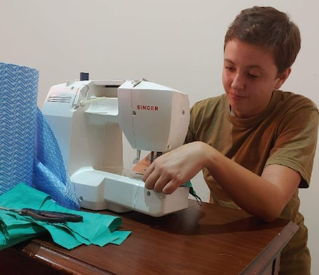 Staff Sgt. Kalynn Mitchell using a sewing machine.