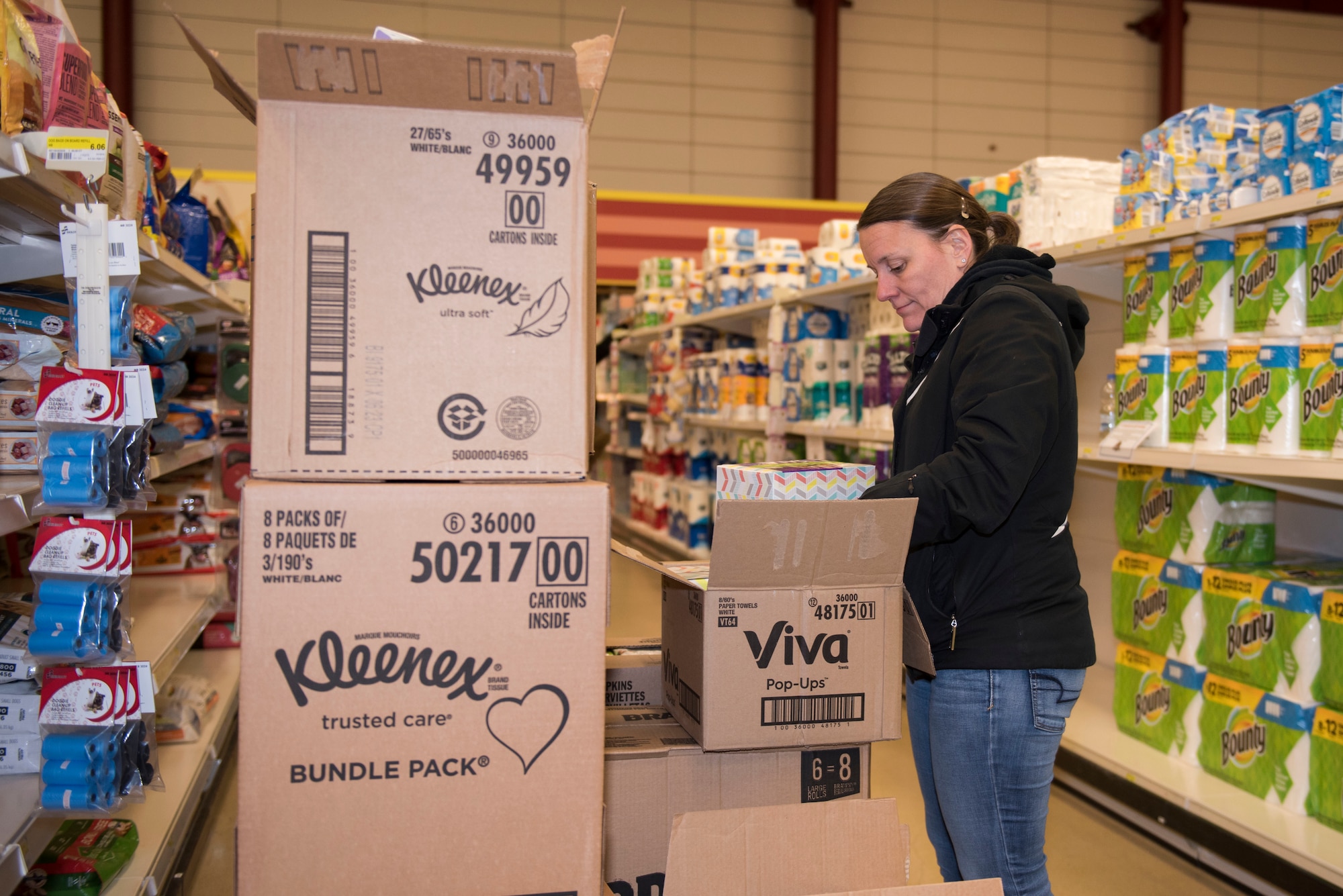 RAF Alconbury and RAF Molesworth employees and volunteers restock shelves at the base commissary at RAF Alconbury England, March 20, 2020. Volunteers answered the call to support the community to ensure service members and their families had access to essential items amid COVID-19. (U.S. Air Force photo by Airman 1st Class Jennifer Zima)