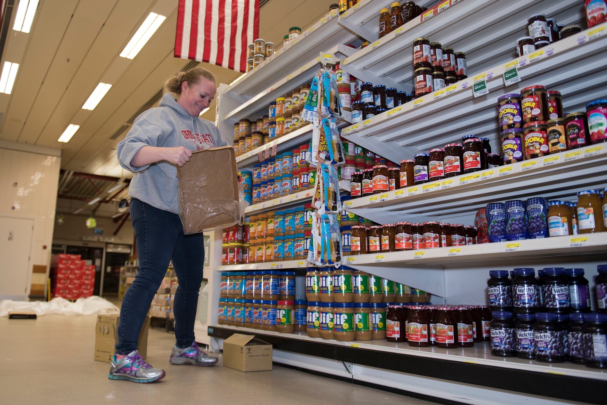 RAF Alconbury and RAF Molesworth employees and volunteers restock shelves at the base commissary at RAF Alconbury England, March 20, 2020. Volunteers answered the call to support the community to ensure service members and their families had access to essential items amid COVID-19. (U.S. Air Force photo by Airman 1st Class Jennifer Zima)