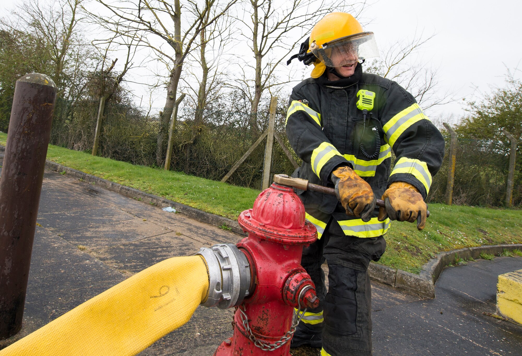 A firefighter with the 423rd Civil Engineer Squadron turns on a fire hydrant during confined spaces training at RAF Alconbury, England on March 30, 2020. This type of training helps the firefighters maintain readiness and stay proficient in their craft. (U.S. Air Force photo by Master Sgt. Brian Kimball)