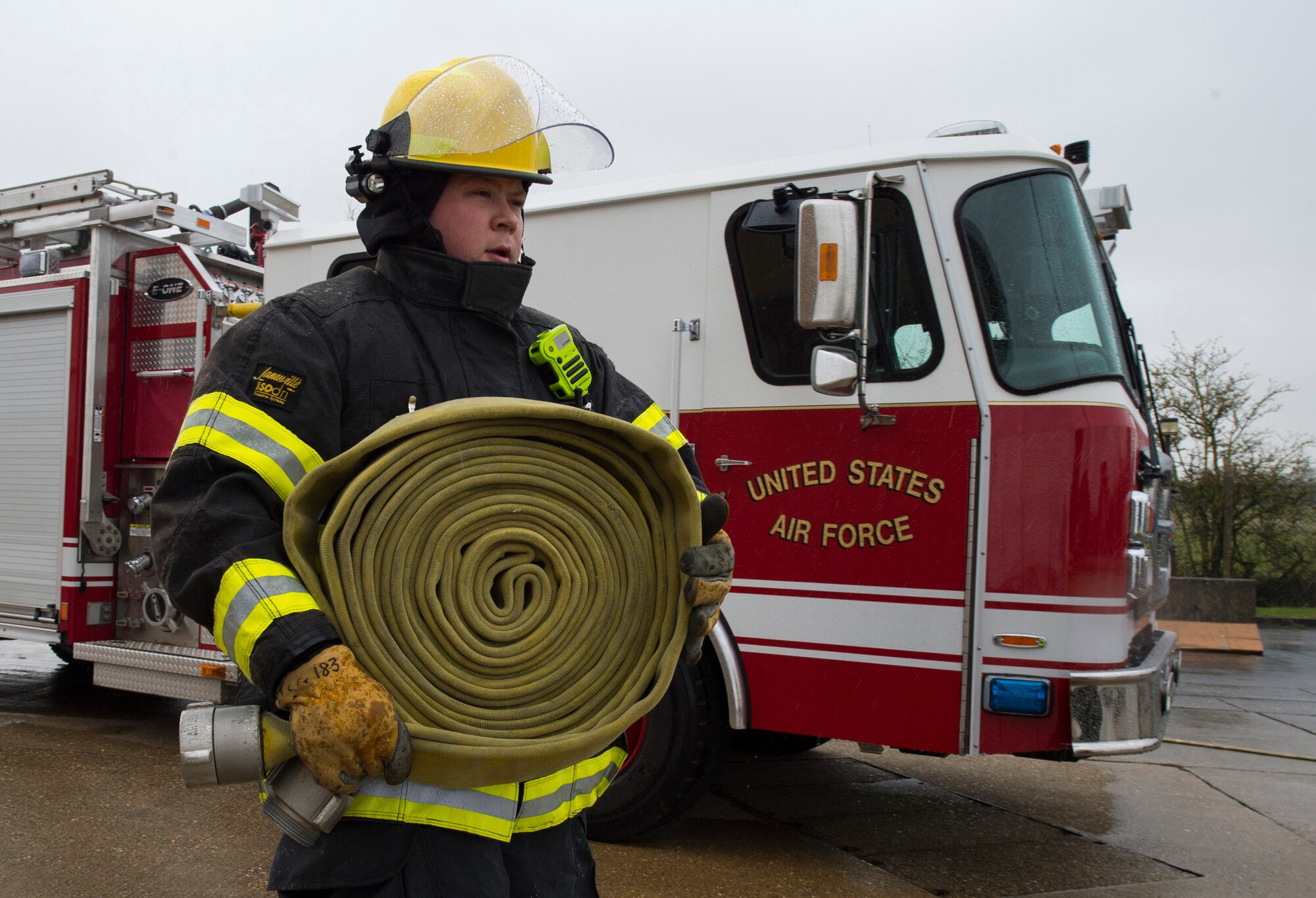 Firefighters with the 423rd Civil Engineer Squadron roll up a firehose during confined spaces training at RAF Alconbury, England on March 30, 2020. This type of training helps the firefighters maintain readiness and stay proficient in their craft. (U.S. Air Force photo by Master Sgt. Brian Kimball)