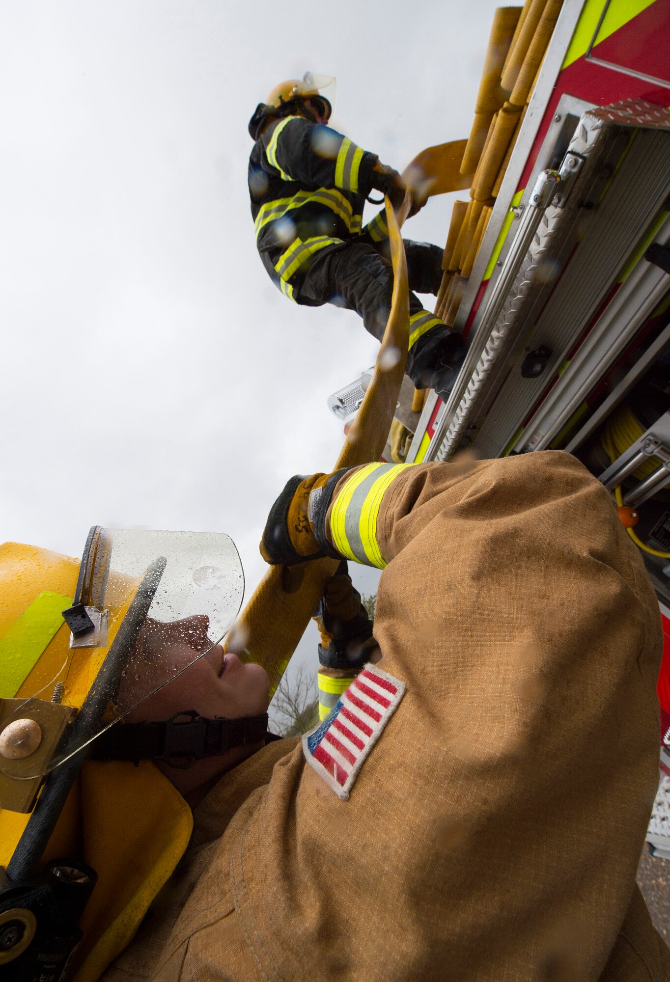 Firefighters with the 423rd Civil Engineer Squadron roll up a firehose during confined spaces training at RAF Alconbury, England on March 30, 2020. This type of training helps the firefighters maintain readiness and stay proficient in their craft. (U.S. Air Force photo by Master Sgt. Brian Kimball)