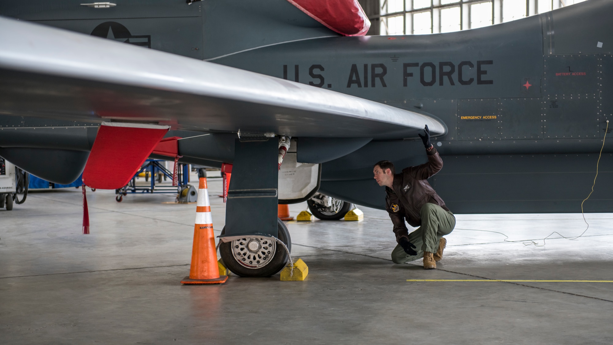 Maj. Marc Nichols, 452nd Flight Test Squadron Assistant Director of Operations, conducts a walk-through inspection of an RQ-4 Global Hawk remotely-piloted aircraft at Edwards Air Force Base, California, April 6. (Air Force photo by Giancarlo Casem)