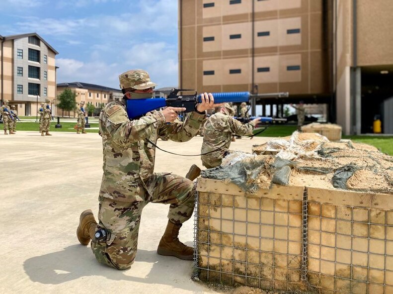 Trainees in basic military training (BMT) learn defensive fighting positions in preparation for BEAST (Basic Expeditionary Airman Skills Training) on Joint Base San Antonio-Lackland, Texas, April 8. This was the first day mask wear was implemented at BMT as a required safety measure during the COVID-19 pandemic.