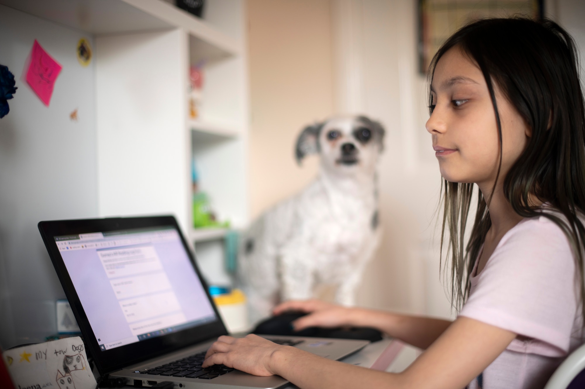 Kaileena Nuñez works on an assignment from an online school session while being quarantined at her home during the COVID-19 outbreak, April 1, 2020. Students continue their education through a virtual learning platform with their school. (U.S. Air Force photo by Tech. Sgt. Emerson Nuñez)