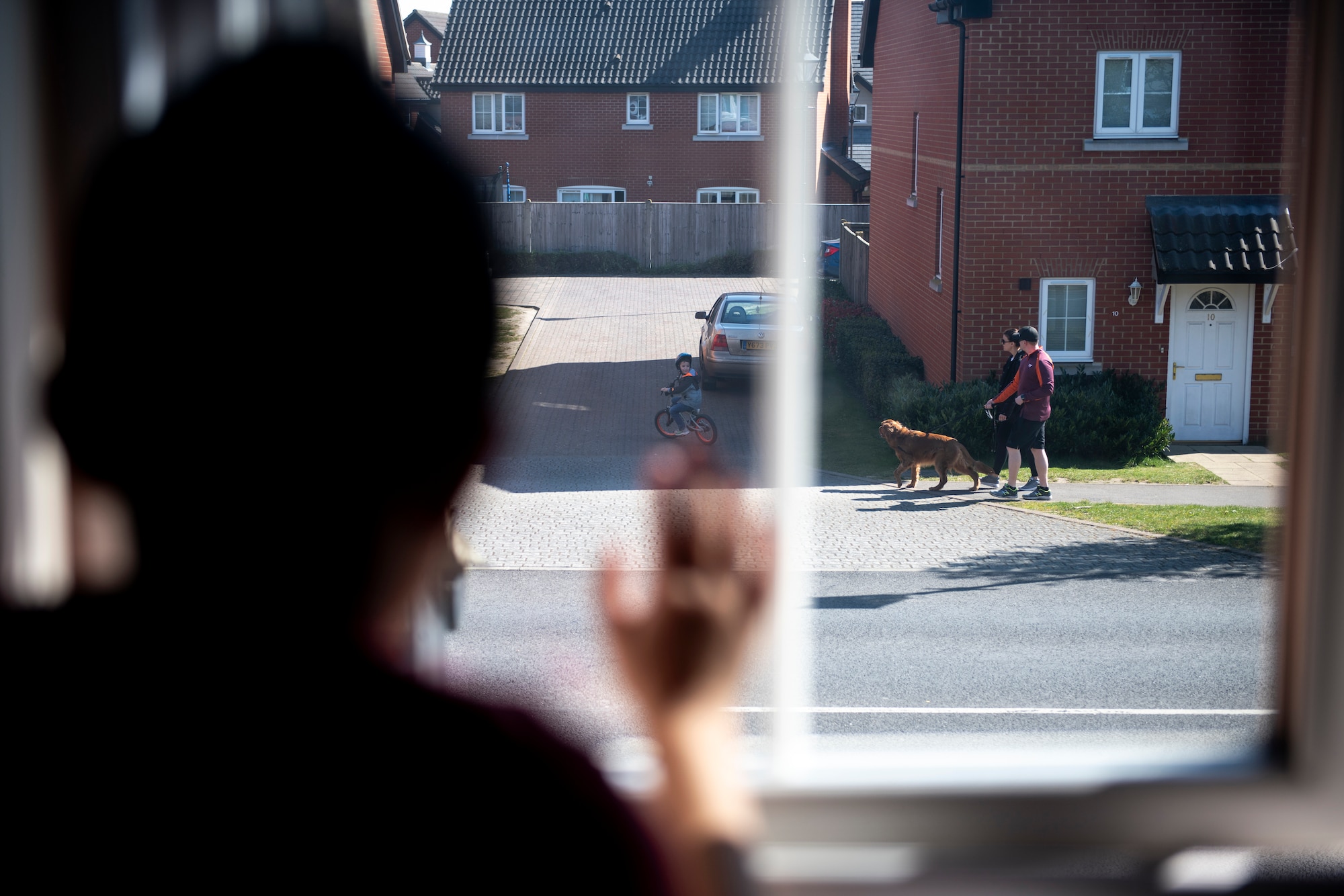 Nolan Nuñez peers out his bedroom window while being quarantined for two weeks at his home with his family during the COVID-19 outbreak, April 5, 2020. The health of the Air Force is a top priority and quarantine is sometimes a necessary precaution to prevent further spread of the virus. (U.S. Air Force photo by Tech. Sgt. Emerson Nuñez)