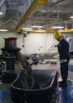 ATLANTIC OCEAN (Dec. 17, 2019) Boatswain’s Mate 2nd Class Hanna Rovillard observes the anchor chain in the hose pipe of the fo'c'sle during an anchor drop evolution aboard the Wasp-class amphibious assault ship USS Iwo Jima (LHD 7), Dec. 17, 2019. Iwo Jima is underway conducting sea trials in the Atlantic Ocean. (U.S. Navy photo by Mass Communication Specialist 2nd Class Andrew J Sneeringer/Released)