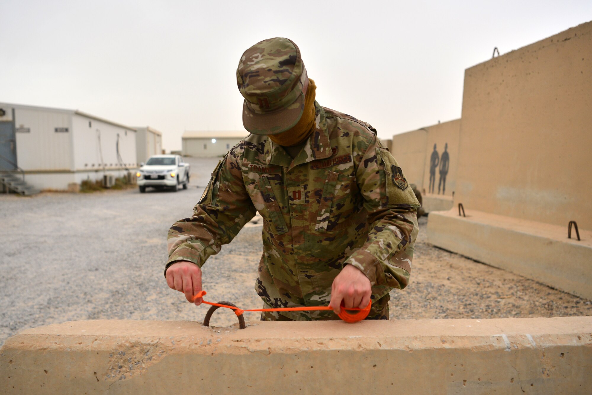 Airman ties reflective tape to barrier