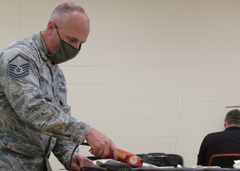 Master Sgt. Bob Bryan, 315th Aircrew Flight Equipment superintendent, cuts materials used to make face masks at Joint Base Charleston, S.C., April 8, 2020. The masks are intended to help mitigate the spread of infectious diseases. The shop started producing the masks earlier this week and have already made more than 500 masks.
