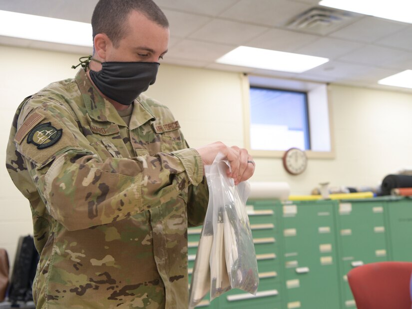 Staff Sgt. Matthew Kinard, 437th Operations Support Squadron aircrew flight equipment shift supervisor, seals bags of masks at Joint Base Charleston, S.C., April 8, 2020. The masks are intended to help mitigate the spread of infectious diseases. The shop started producing the masks earlier this week and have already made more than 500.