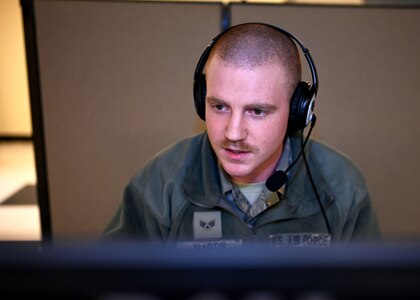 Senior Airman Connor Martin, crew chief, 157th Air Refueling Wing, New Hampshire Air National Guard, works at a makeshift call center at the state fire academy in Concord, April 7, 2020.