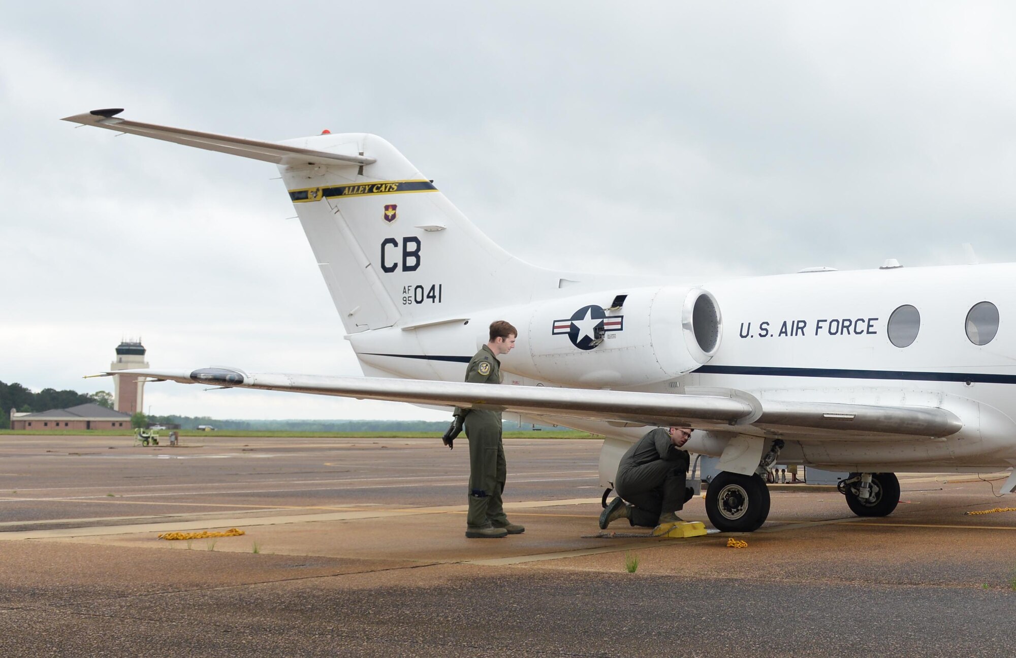 Two 14th Flying Training Wing pilots conduct preflight checks on a T-1A Jayhawk April 9, 2020, at Columbus Air Force Base, Miss. The T-1 is a medium-range, twin-engine jet trainer used in the advanced phase of specialized undergraduate pilot training for students selected to fly airlift or tanker aircraft. Pilot training has been deemed essential operations and continues amid the COVID-19 pandemic. (U.S. Air Force photo by Airman 1st Class Davis Donaldson)