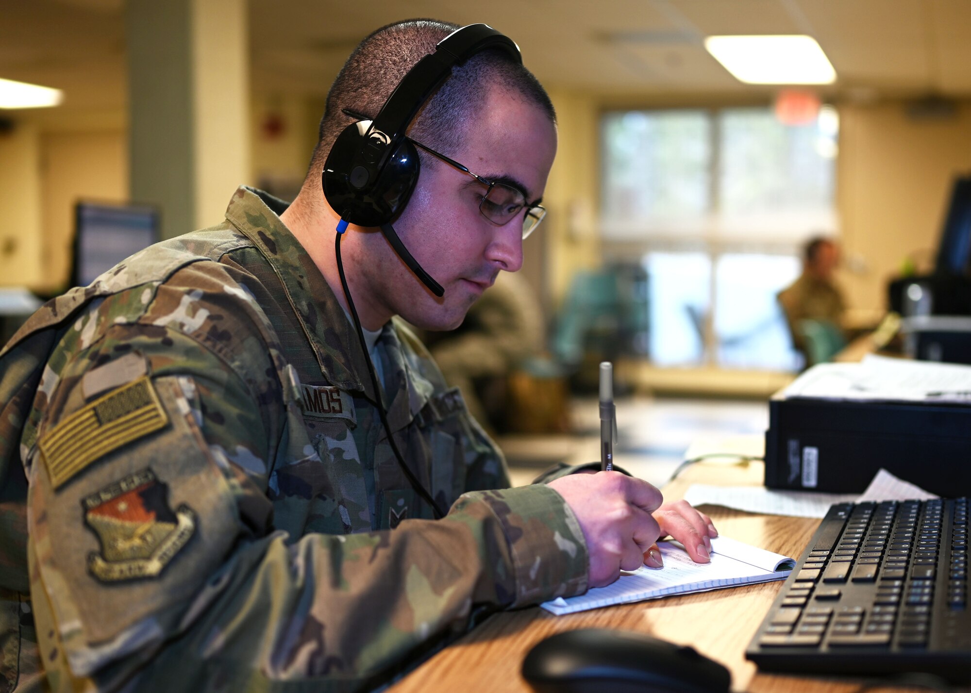 Staff Sgt. Walter Ramos, crew chief, 157th Air Refueling Wing, New Hampshire Air National Guard, fields calls for unemployment benefits at a makeshift call center at the state fire academy in Concord, April 7, 2020.
