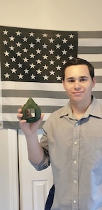 SGT Muhlbach holding a completed 3D printed mask.