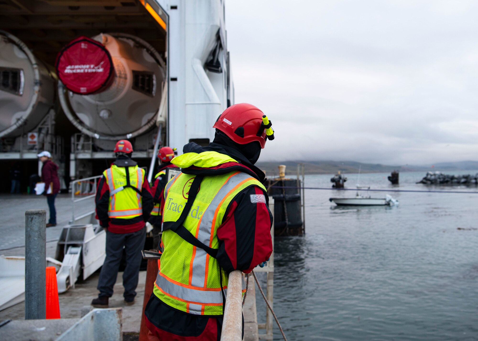 Jason Diaz, TracTide Marine Corporation water operator, conducts a safety check during an offload of Delta IV Heavy boosters April 5, 2020, at Vandenberg Air Force Base, Calif. The TracTide members are based out of Port Hueneme, Calif., and assisted during the offload of the boosters to ensure the safety of the members and the United Launch Alliance barge, known as the RocketShip. (U.S. Air Force photo by Senior Airman Aubree Owens)