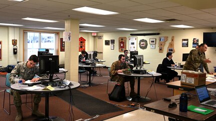 Airmen from the 157th Air Refueling Wing, New Hampshire Air National Guard, work a makeshift call center in the basement of the state fire academy in Concord, April 7, 2020. Guardsmen help field thousands of unemployment benefit applications made through the center per day.