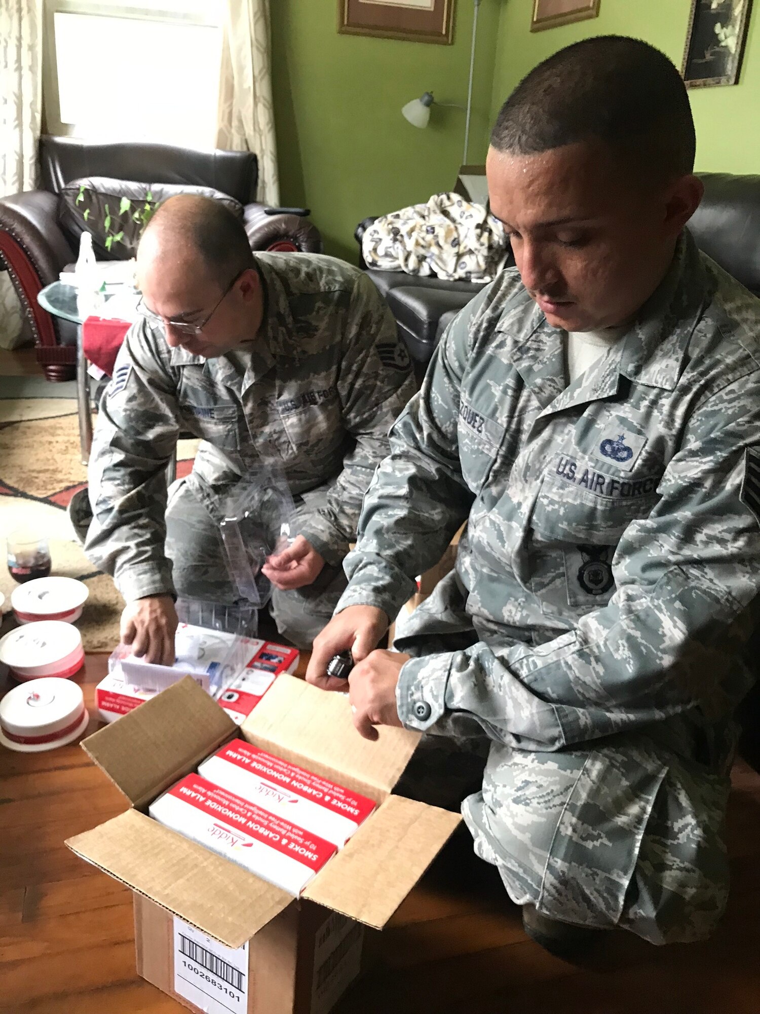 Staff Sgt. Carlos Vazquez of the 104th Fighter Wing Mission Support Group, translates to help communicate the Airmen of the 104th Fighter Wing and other community partners are there to help. Airmen from the 104th Fighter Wing responded to helping the residents of Lawrence, Massachusetts who were affected by the gas explosions and fires. The Airmen assisted Columbia Gas to distribute fire and carbon monoxide detectors as a safety precaution, September 26, 2018. (U.S. Air National Guard Photos by Senior Master Sgt. Julie Avey)