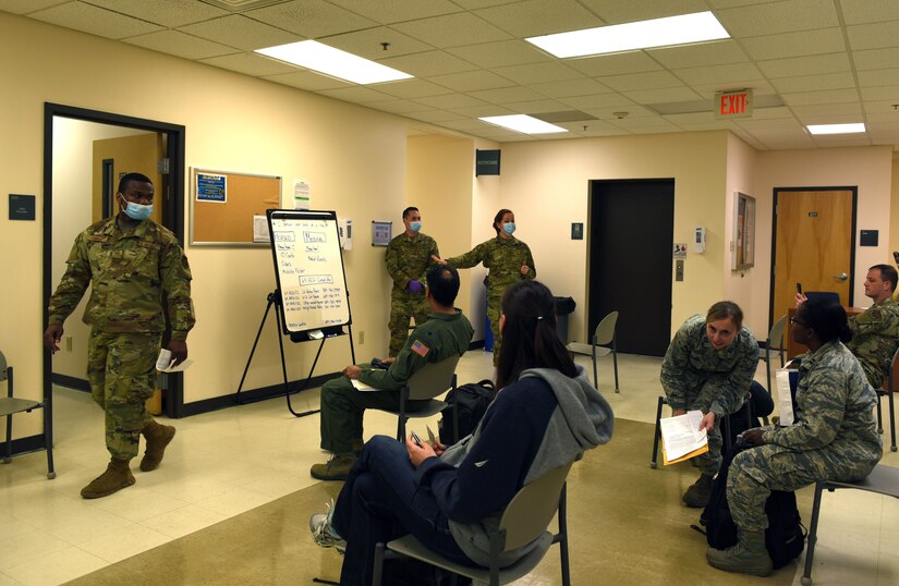Photo of 514th Force Support Squadron commander talking to incoming activated Guard and Reservist service members.
