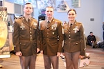 Sergeant Major of the Army Dan Dailey, center, stands with soldier models wearing the Army green service uniform during its national debut at the Army-Navy game
