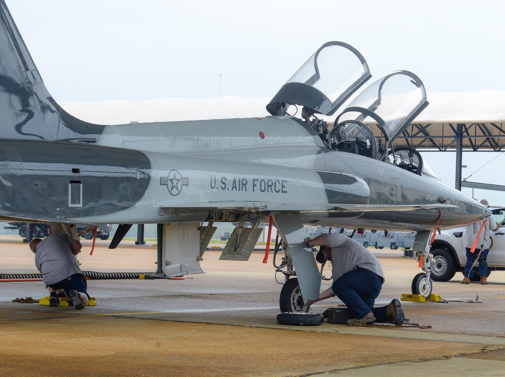 Two M1 Support Services maintainers inspect a T-38 Talon, April 8, 2020, at Columbus Air Force Base, Miss. Columbus Air Force Base utilizes contracted maintenance to keep training aircraft in pristine condition. Maintainers have been vital to ensuring pilot training continues amid the COVID-19 pandemic. (U.S. Air Force photo by Airman 1st Class Davis Donaldson)