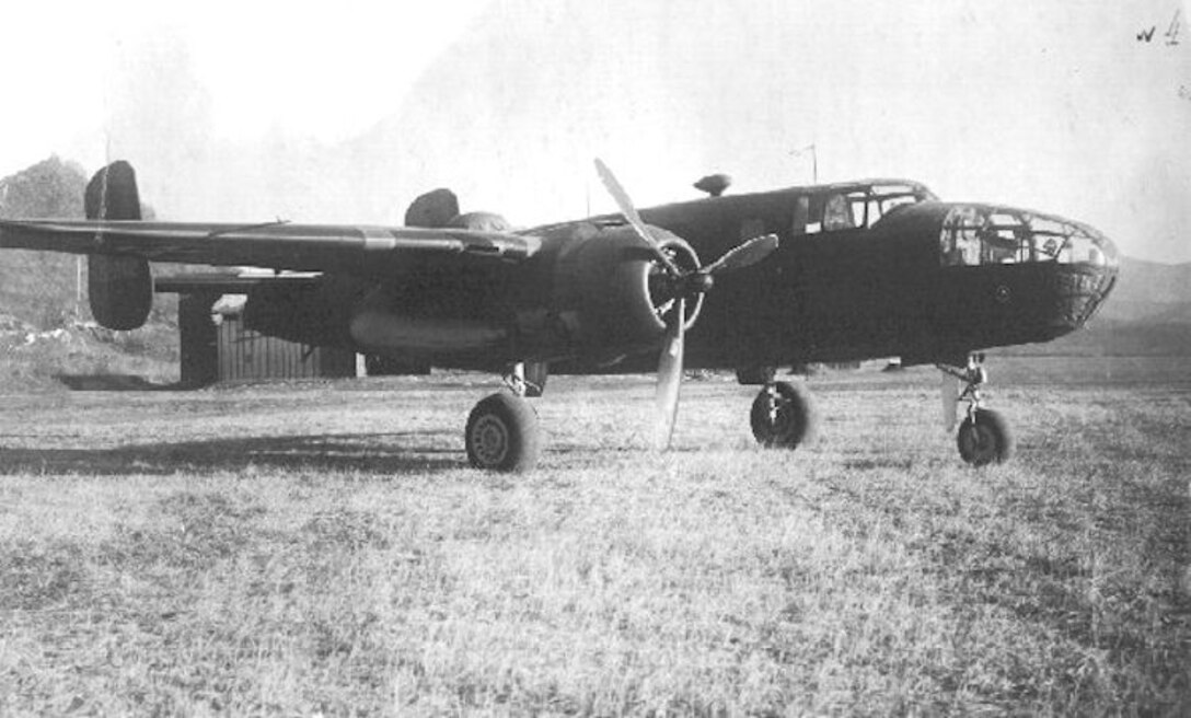 Plane sits in a field.