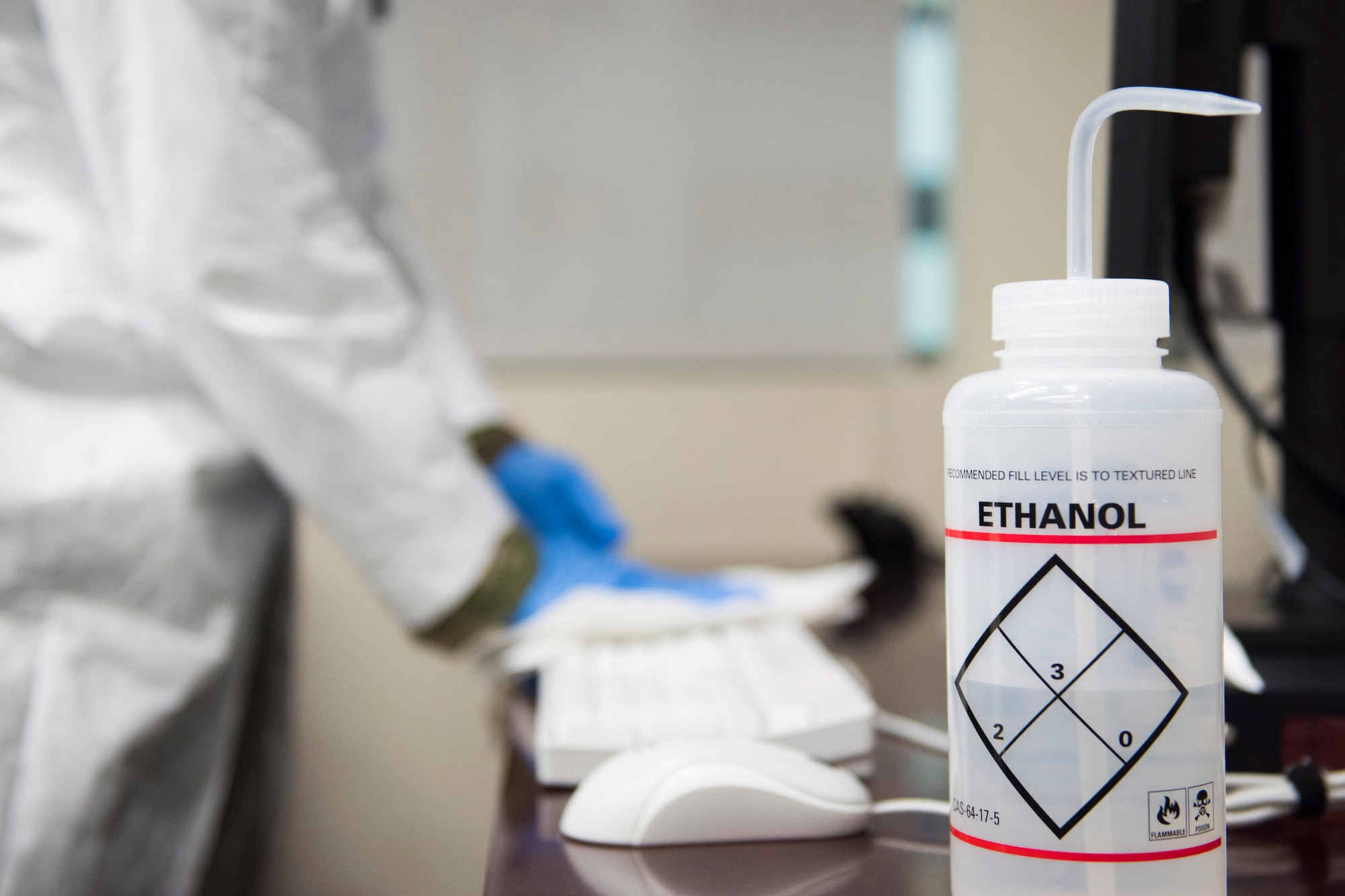 A member of the Air Force Technical Applications Center, Patrick AFB, Fla., uses a diluted solution of ethanol and deionized water to sanitize items within the nuclear treaty monitoring center in the wake of the COVID-19 pandemic.  (U.S. Air Force photo by Matthew S. Jurgens)