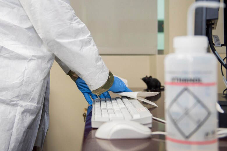 A member of the Air Force Technical Applications Center, Patrick AFB, Fla., uses a diluted solution of ethanol and deionized water to sanitize items within the nuclear treaty monitoring center in the wake of the COVID-19 pandemic.  (U.S. Air Force photo by Matthew S. Jurgens)