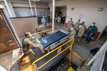 Members of the West Virginia National Guard’s Task Force Chemical, Biological, Radiological and Nuclear (CBRN) Response Enterprise (CRE) (TF-CRE) and Task Force Sustainment (TF-Sustainment), assist staff of St. Joseph Hospital, Charleston, West Virginia, to unload beds and additional medical equipment delivered to the hospital in an effort to build statewide medical surge capacity during on-going COVID-19 pandemic response, April 9, 2020. The equipment, resourced from a closed hospital in Fairmont, West Virginia, was delivered by members of the West Virginia State Police, West Virginia Division of Highways, and West Virginia Division of Homeland Security and Emergency Management, as part of a whole of government partnership uniting local, state and federal agencies in coordinated response efforts. (U.S. Army National Guard photo by Edwin L. Wriston)