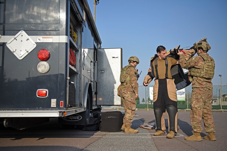 Staff Sgt. Tyler McMillan Wammack, 8th Civil Engineer Squadron Explosive Ordnance Disposal technician, puts on a bomb suit prior to entering the base post office during a training event at Kunsan Air Base, Republic of Korea, April 8, 2020. Training benefits EOD technicians by giving them the opportunity to gain experience on how improvised explosive devices are built and how best to identify them in the field. (U.S. Air Force photo by Staff Sgt. Mackenzie Mendez)