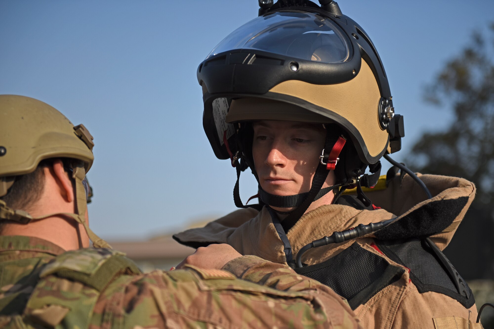 Staff Sgt. Tyler McMillan Wammack, 8th Civil Engineer Squadron Explosive Ordnance Disposal technician, puts on a bomb suit prior to entering the base post office during a training event at Kunsan Air Base, Republic of Korea, April 8, 2020. The training event focused on emergency procedures and response actions in regards to a simulated improvised explosive device placed at the post office. (U.S. Air Force photo by Staff Sgt. Mackenzie Mendez)