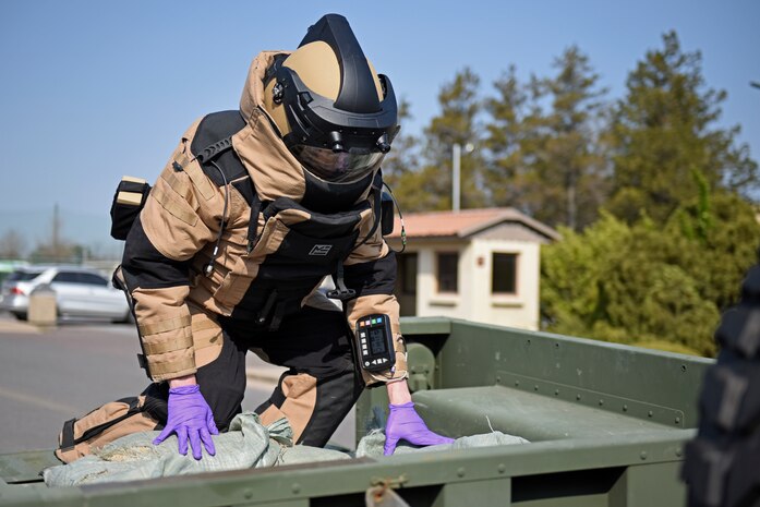 Staff Sgt. Tyler McMillan Wammack, 8th Civil Engineer Squadron Explosive Ordnance Disposal technician, places the simulated improvised explosive device in a trailer for disposal during a training event at Kunsan Air Base, Republic of Korea, April 8, 2020. The training event focused on emergency procedures and response actions in regards to a simulated improvised explosive device placed at the base post office. (U.S. Air Force photo by Staff Sgt. Mackenzie Mendez)