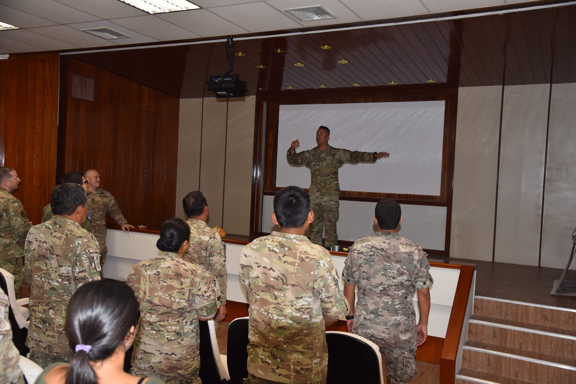 U.S. Air Force Tech. Sgt. Luis Ochoa, 571st Mobility Support Advisory Squadron air advisor, reminds the class about different forklift operation signals during a mobile training team mission with the Peruvian Air Force at Callao Air Base in Lima, Perú. The MTT included three weeks of instruction at Callao and covered three general areas: an introduction to aerial logistics and logistical management mindset, hazardous material management, and cargo loading. (courtesy photo)